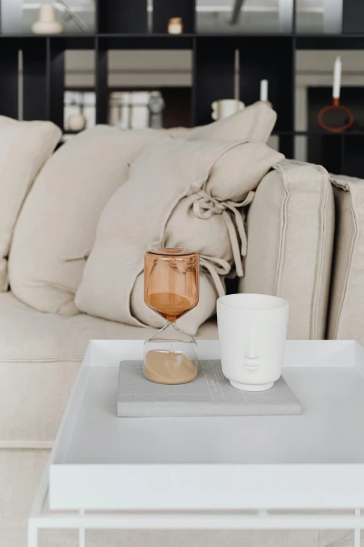 a living room couch with a coffee table and coffee cup