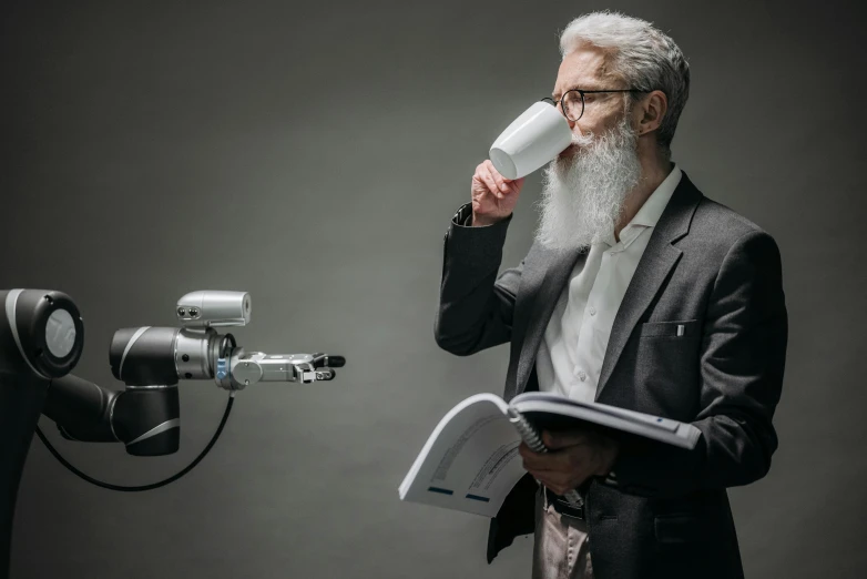 a man in a suit drinking a book next to a camera