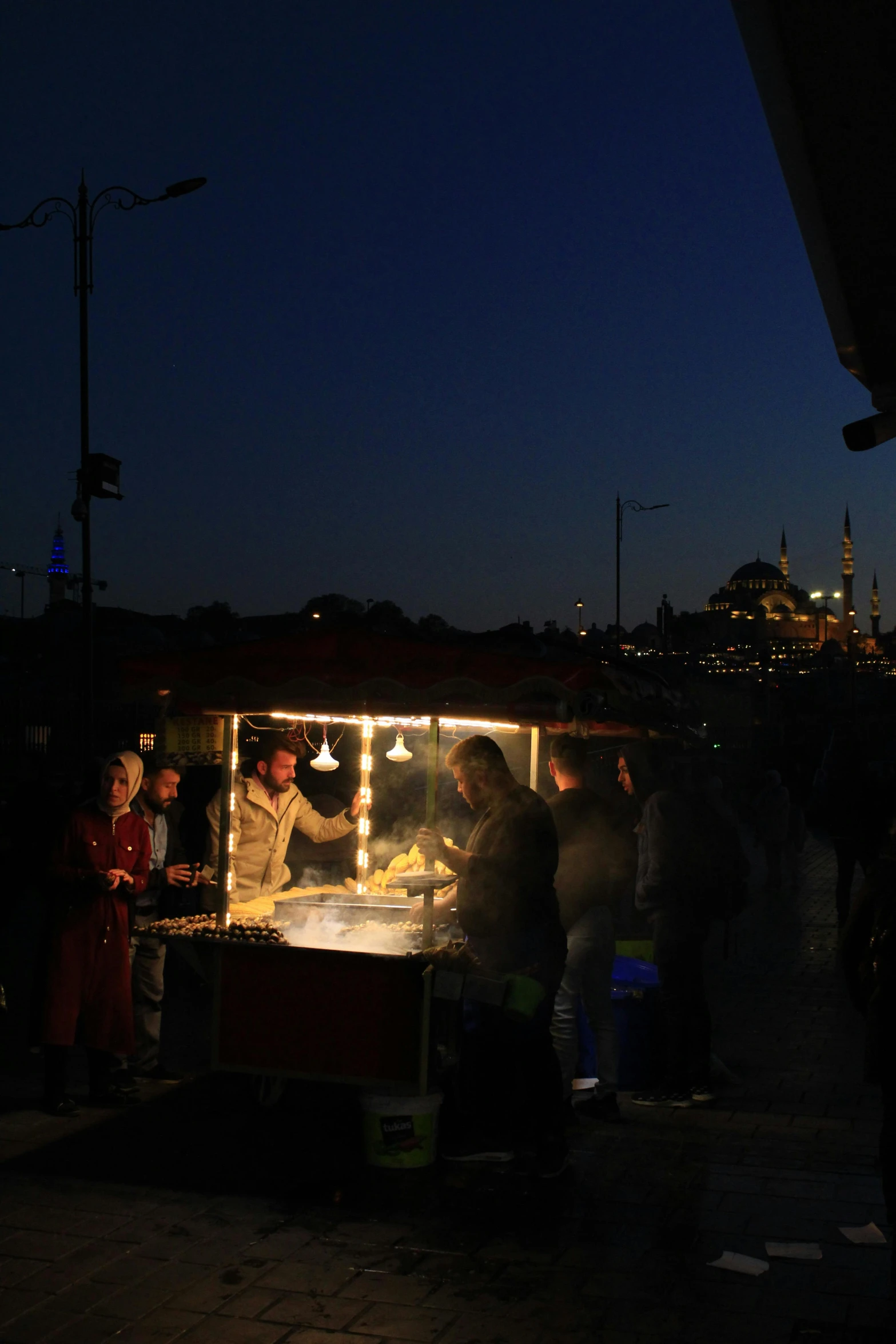 some people are out eating a food on a stand