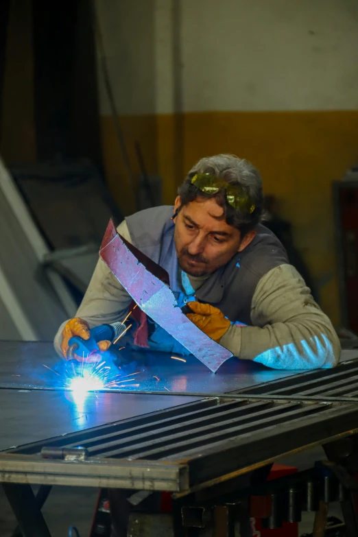 a man working on a piece of equipment in a factory