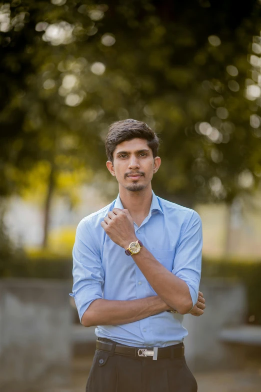 a young man with a blue shirt and brown shorts