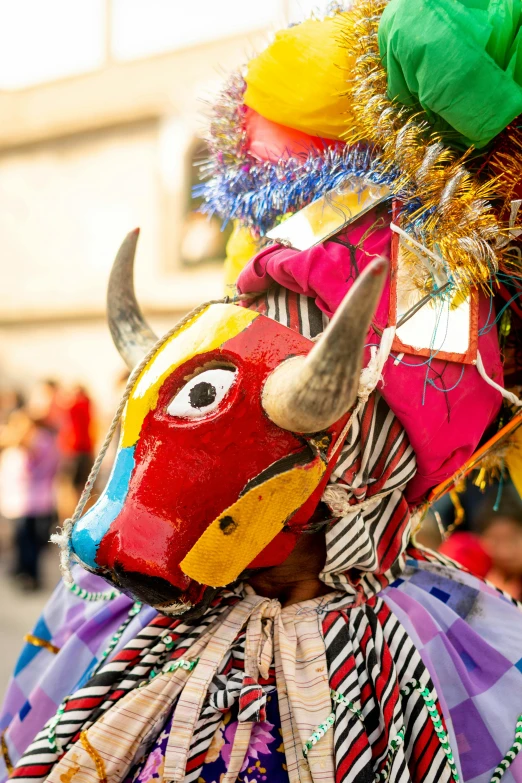 a colorful bull head with horns and feathers