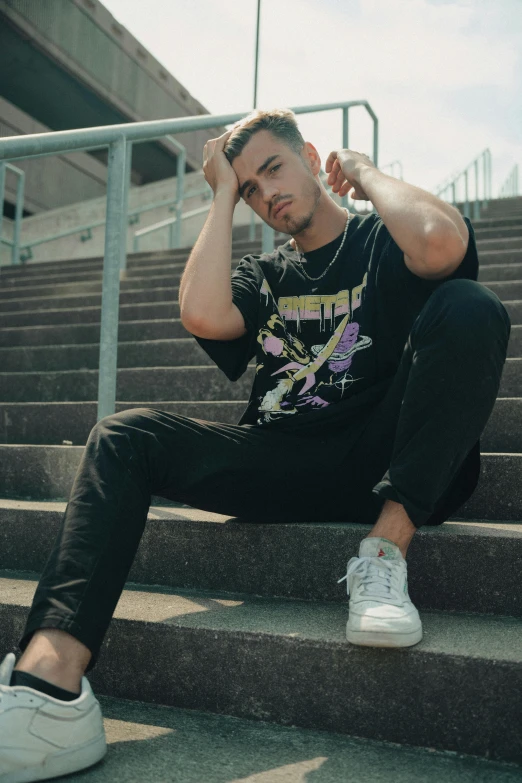 a man sits on the steps outside of a building