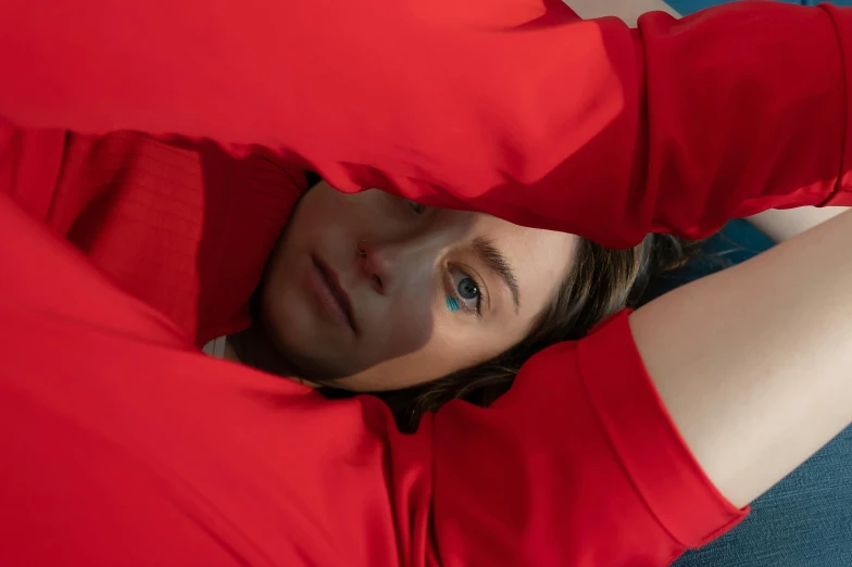 a girl looking out from her red t shirt