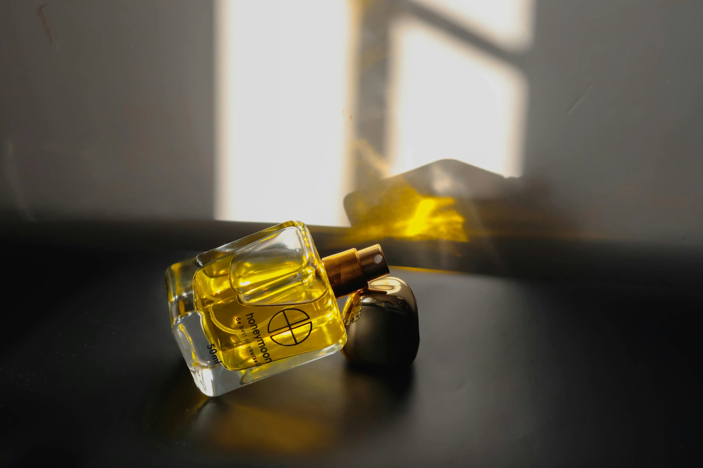 a cigarette resting on a table next to an open bottle of perfume