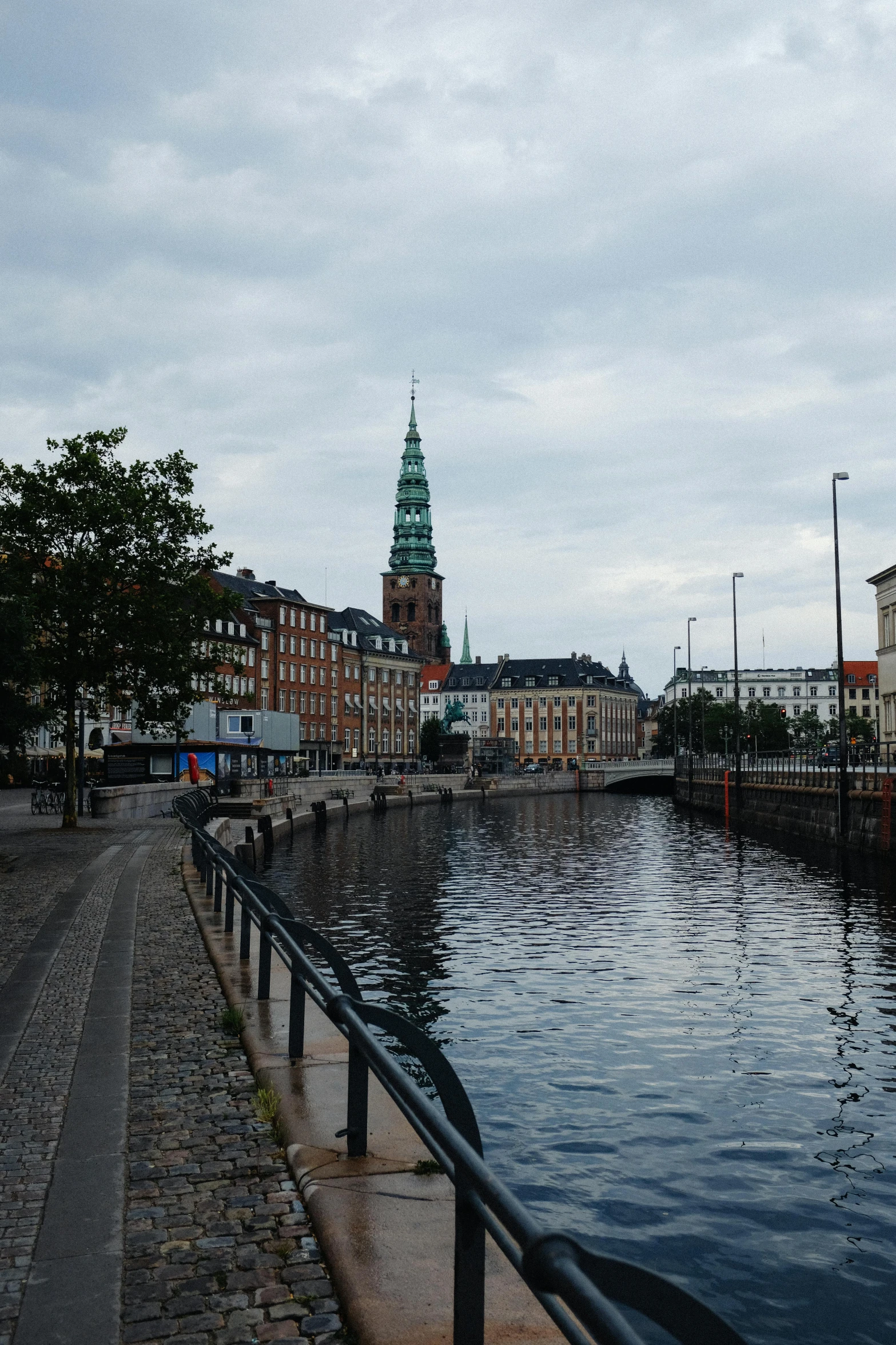 some boats docked on the side of a river near other buildings