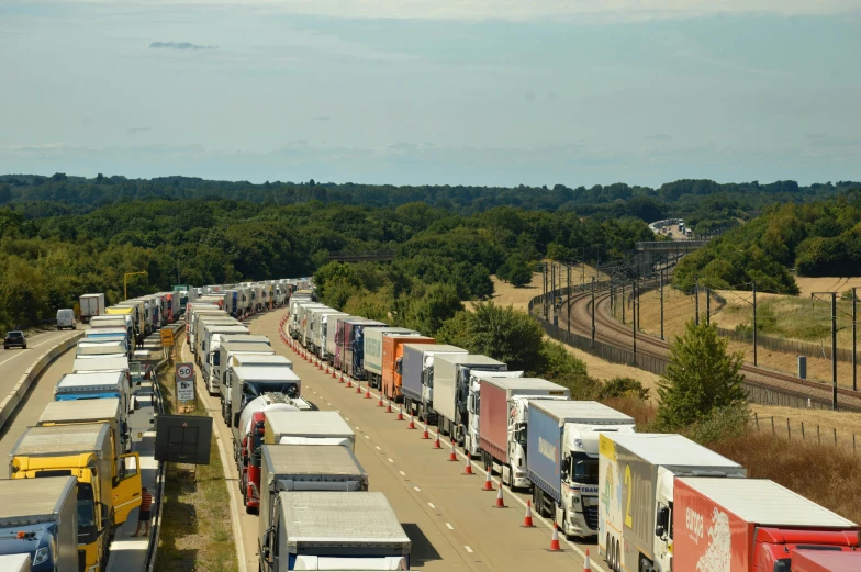 a long line of trucks driving down the road