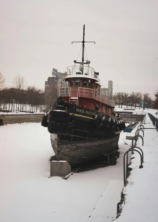 there is a boat docked on the frozen water