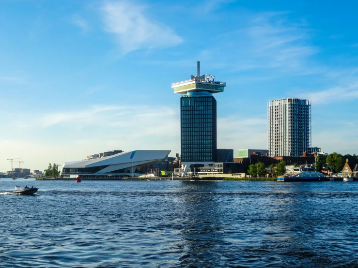 a river with boats on it that are next to tall buildings