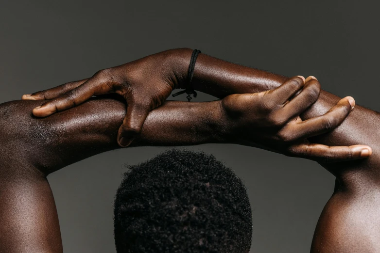 a black woman is holding her hands to her back