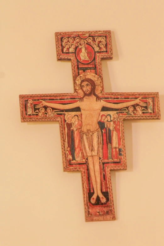 an ornately decorated cross mounted on a wall