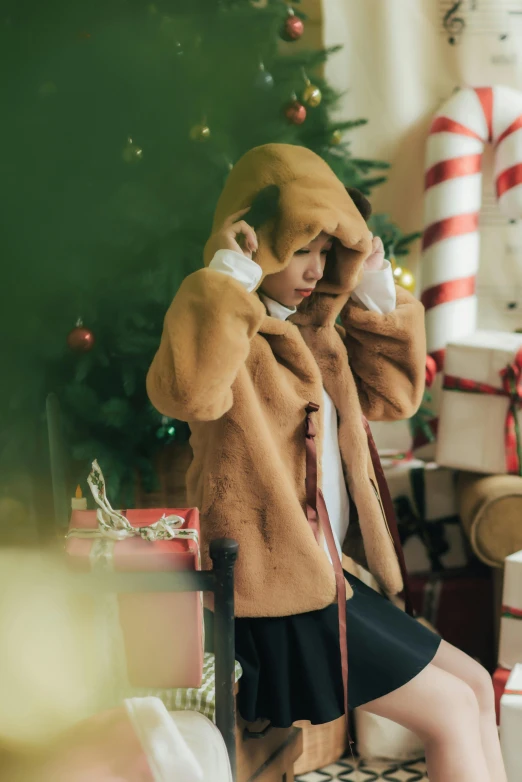 the young woman is wearing a tan teddy bear coat