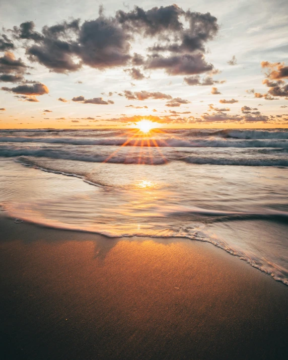 the sun is setting at the beach shore