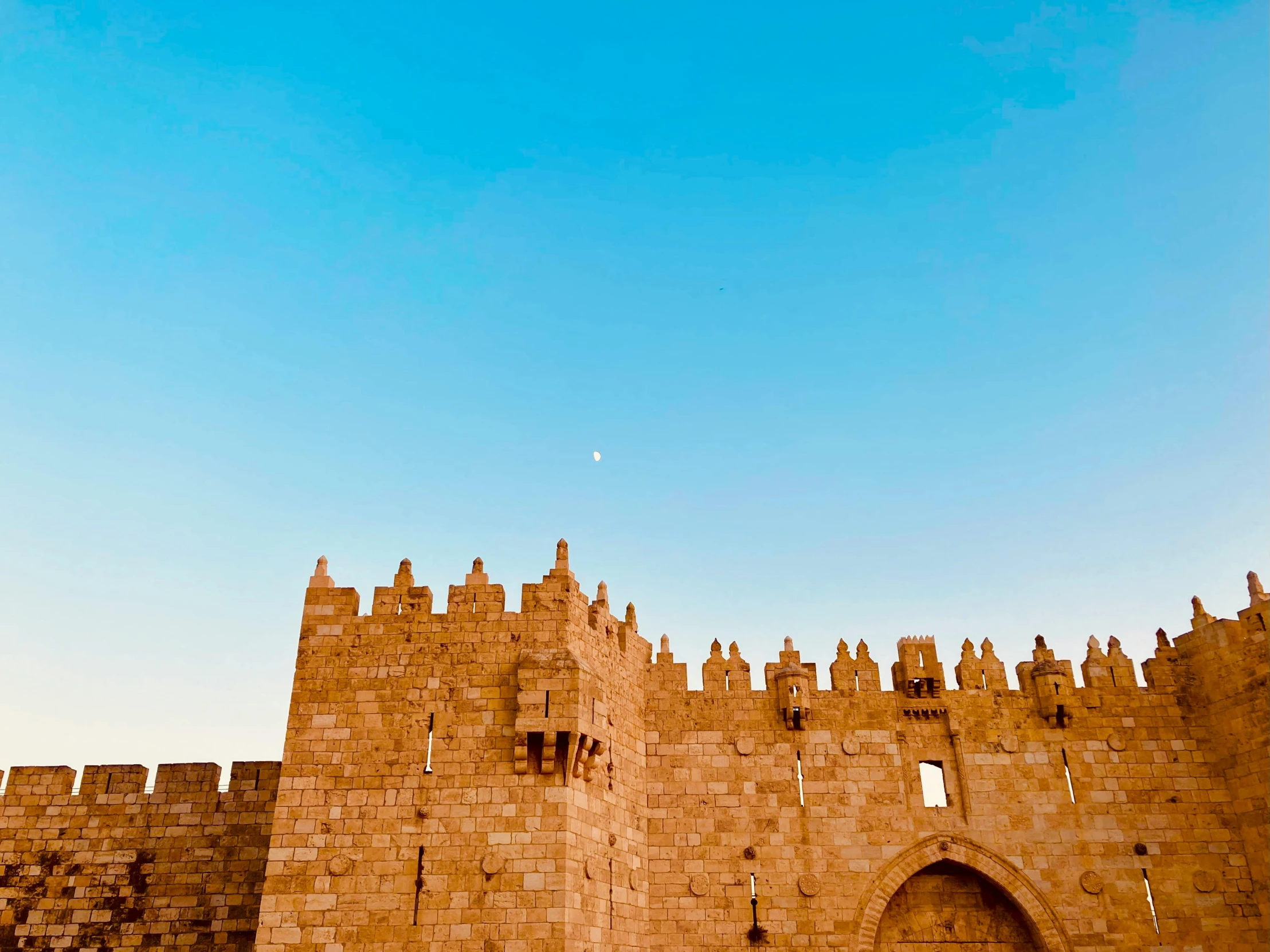 an old stone castle with a clock on it