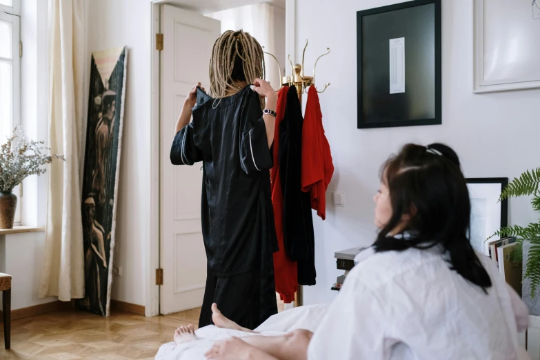 the woman is hanging clothes in her home