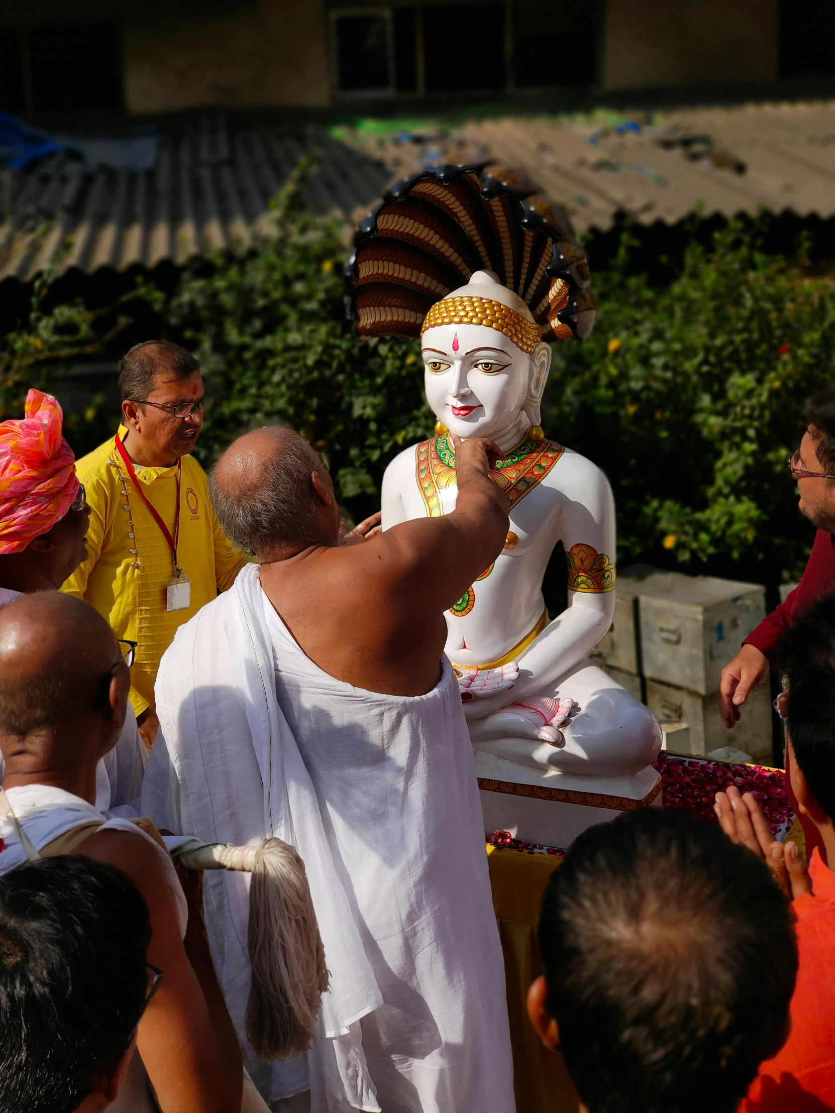 a person dressed in white holding an item