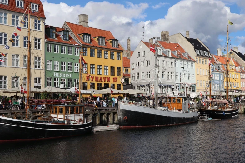 many buildings near one another with a river next to them