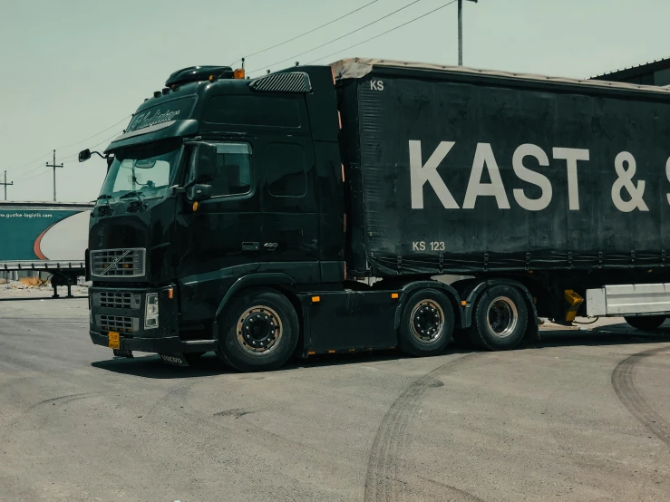 a truck with the words kast & sons on it is parked