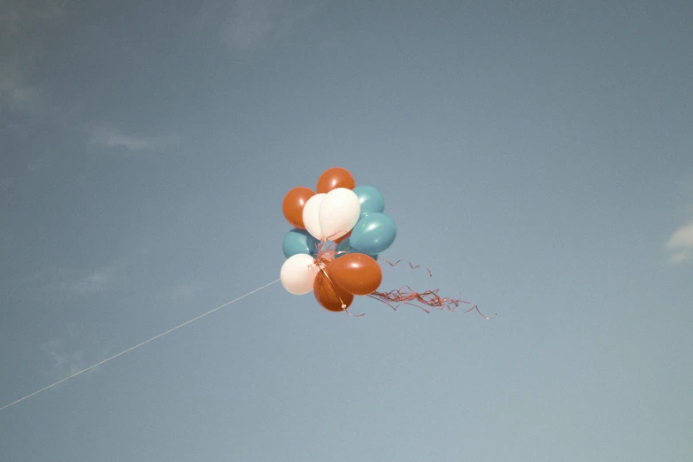 several balloons floating in the air together