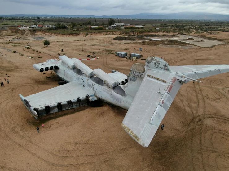 an abandoned aircraft sits in the middle of a desert