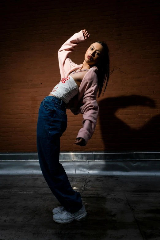 a woman on one leg in a pair of jeans stretching