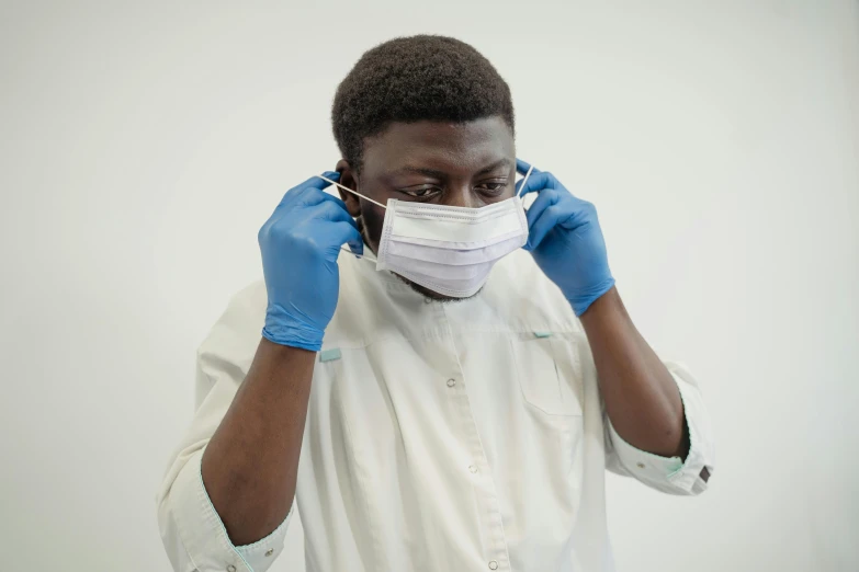 a man wearing a face mask and gloves