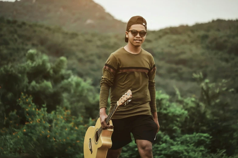 a man holding an acoustic guitar in his hands