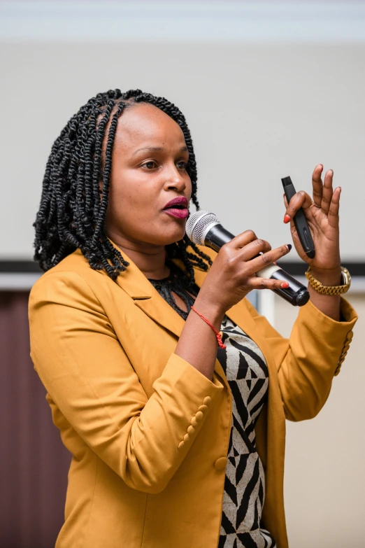 a woman holding a microphone and talking