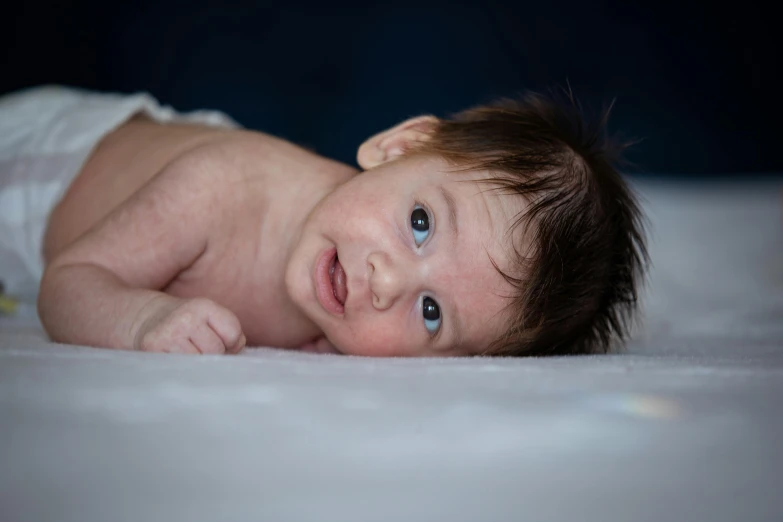 a close - up s of a baby's face and the baby is wearing diapers