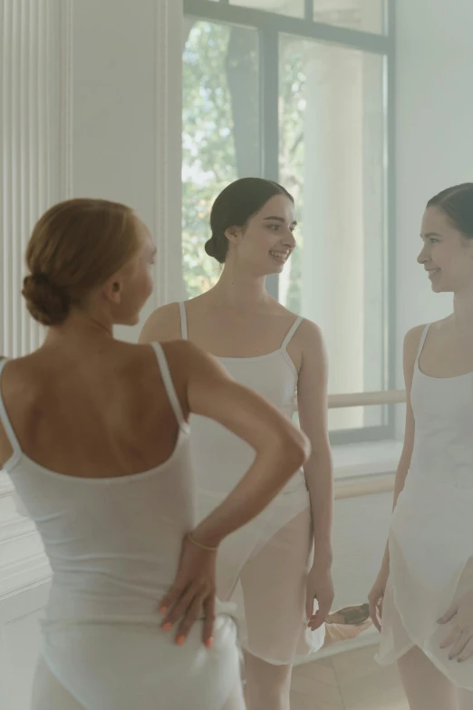 two women are standing next to each other in a bathtub