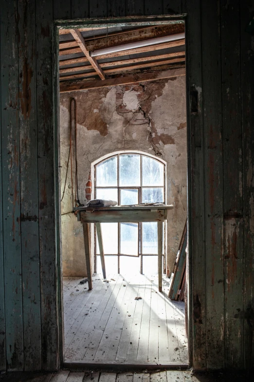 a broken door that leads into a run down house