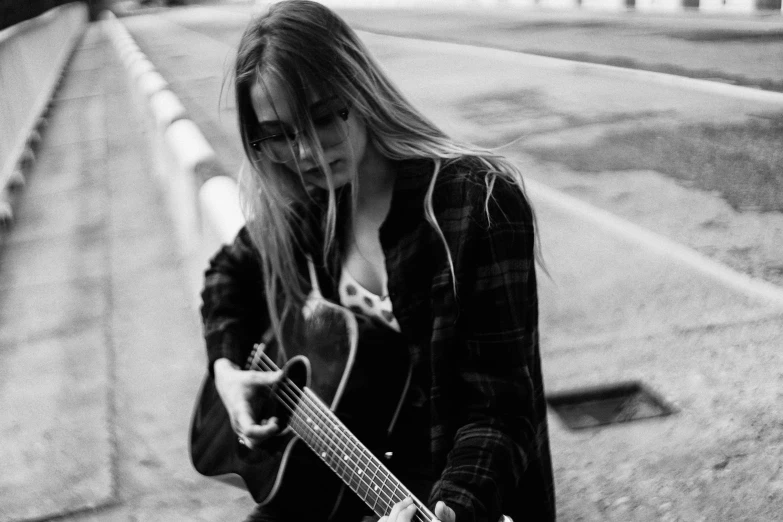 a person with a guitar on the road