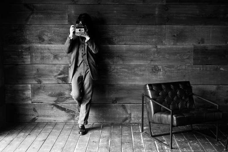 a woman is standing on a tile floor and taking a picture