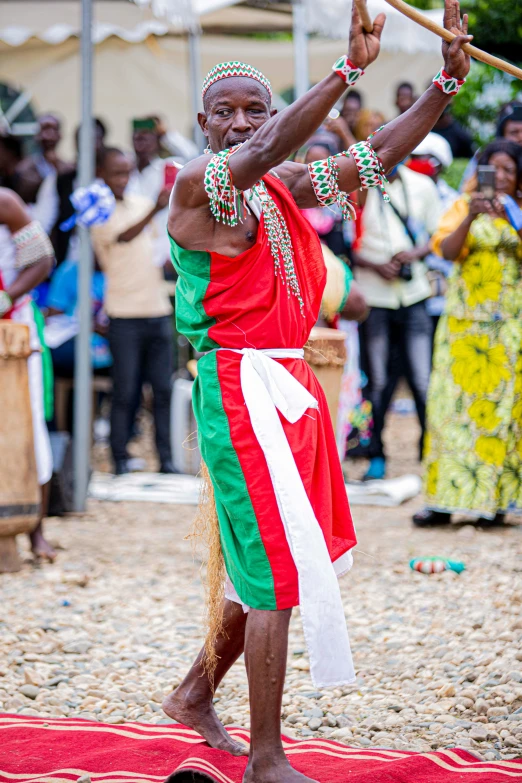 man with big afro holding two large sticks