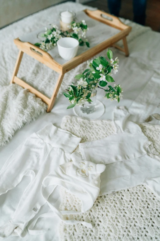 an image of a tray with flowers and a white bed