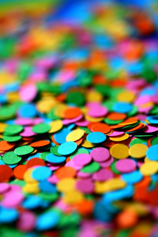 some colored paper circles laying in the middle of a surface