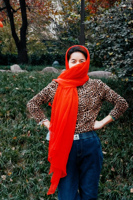 a woman is standing outside in the grass