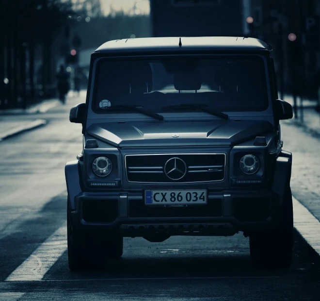 a mercedes g class suv parked on the side of the street