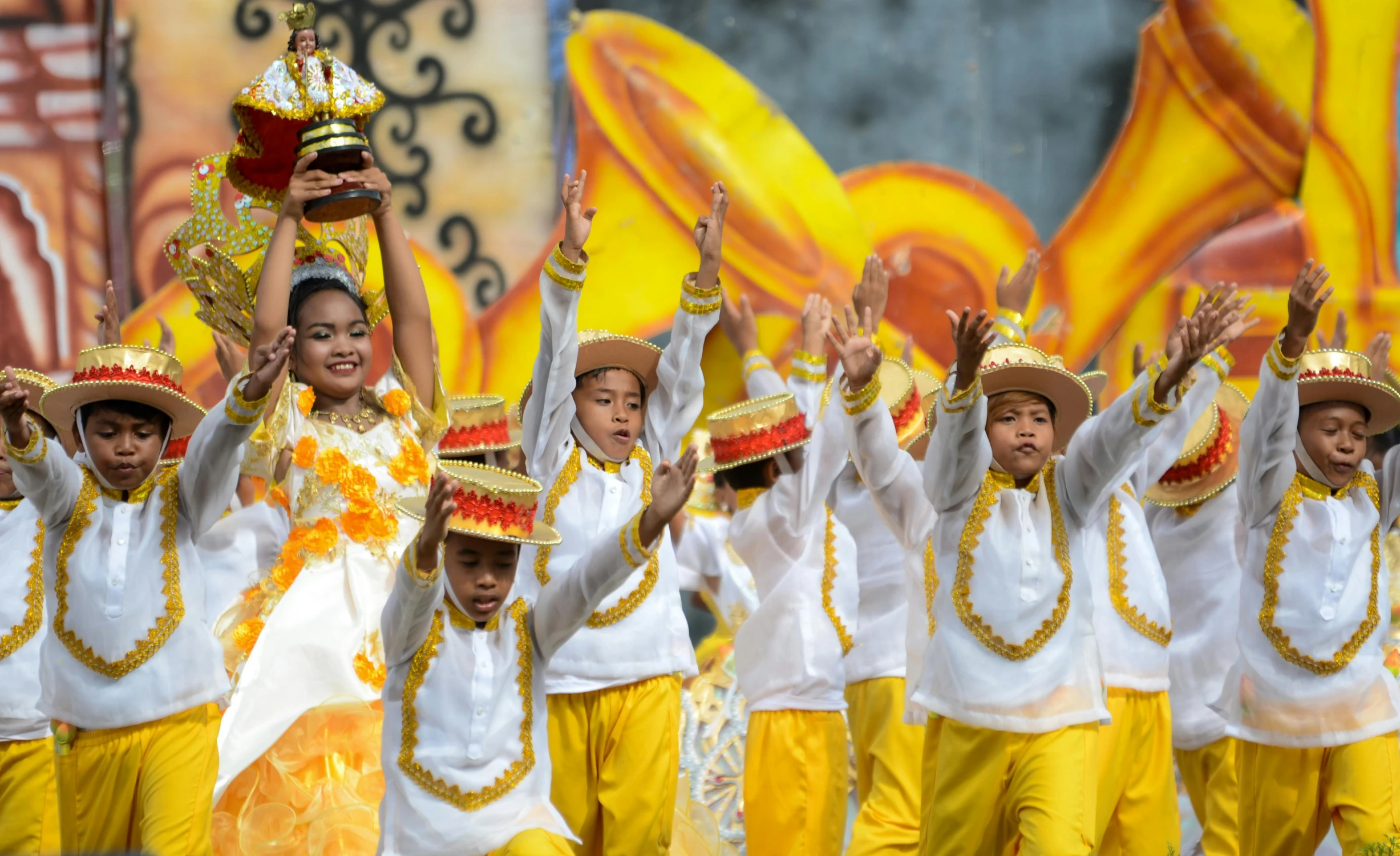 s in the parade, with their arms up and their hands raised