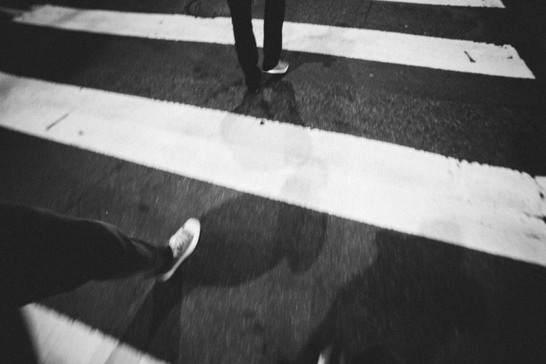 the foot of a person walking across a street