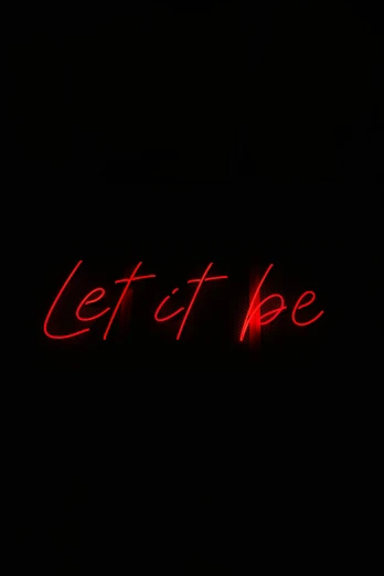 the word let it be written in red neon lights