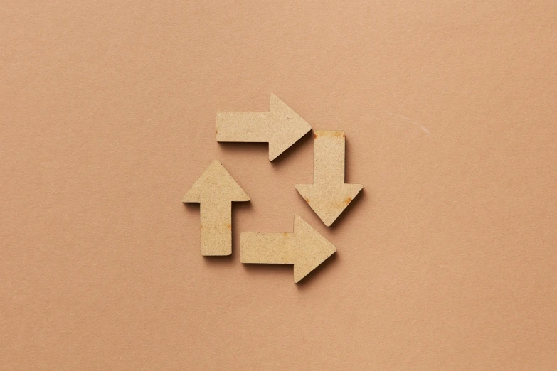 three pieces of wood cut into the shape of arrows