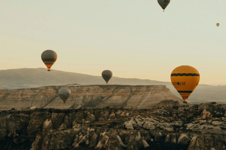 some balloons flying in the air over mountains