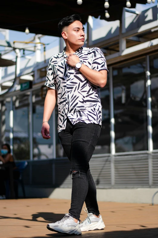 the man is skateboarding on the pavement in front of a building