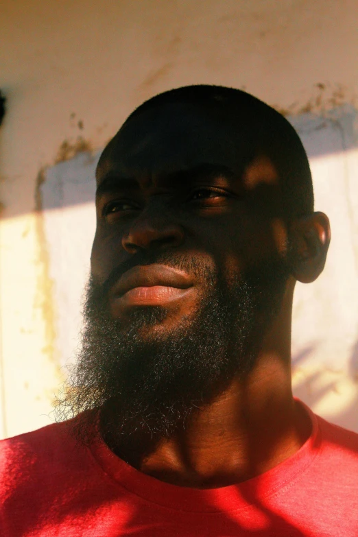 a man with a beard wearing a red t shirt