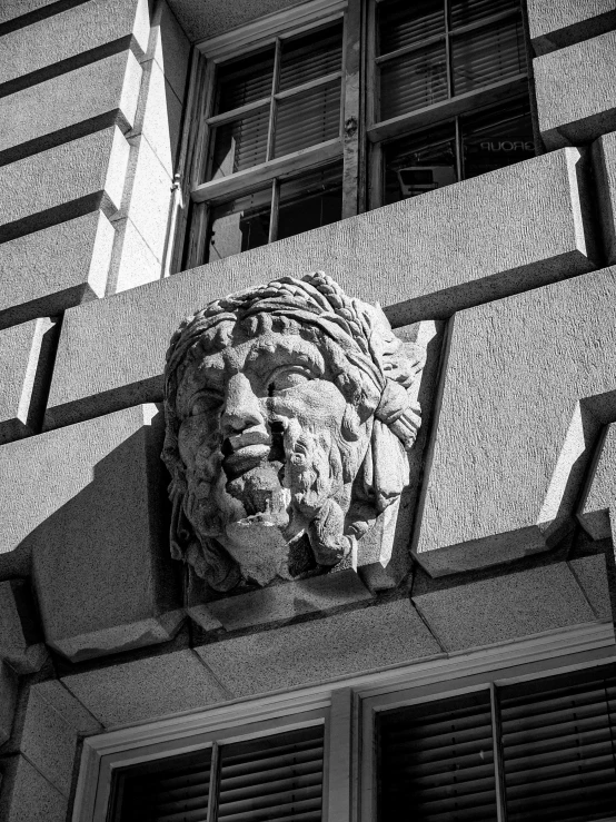 a building with a gargoyle head on the front