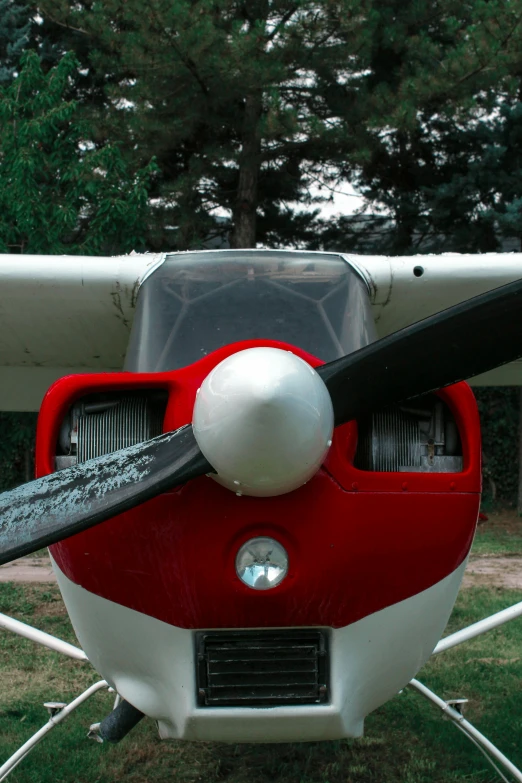 a propeller on an air plane parked at a grassy field