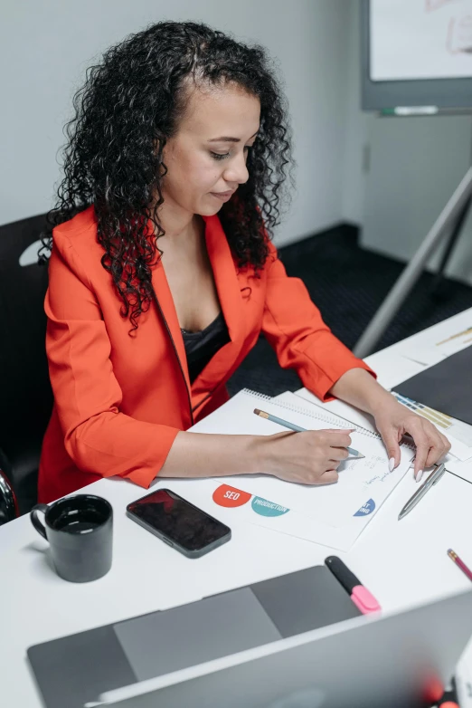 a woman sitting at a desk with a laptop