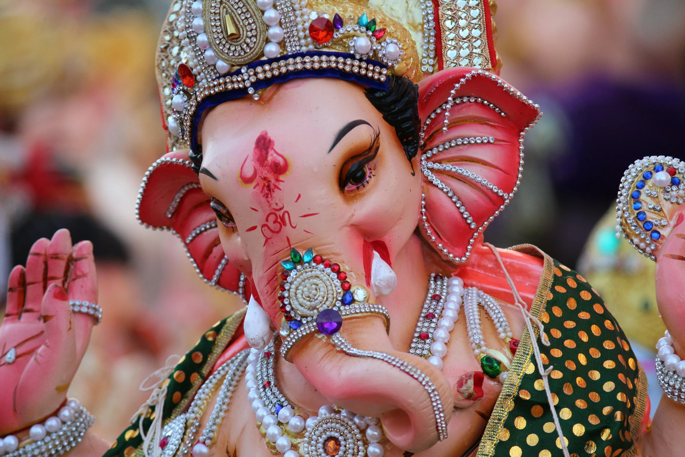 an elephant that has been decorated in a colorful costume