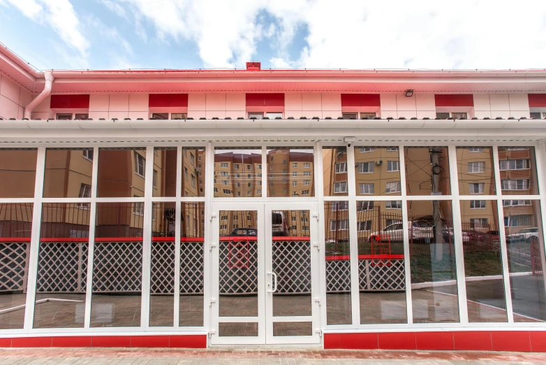 an outside view of a restaurant with several doors on the street